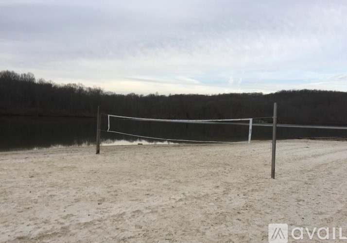 A beach volleyball court with a net and sandy ground.