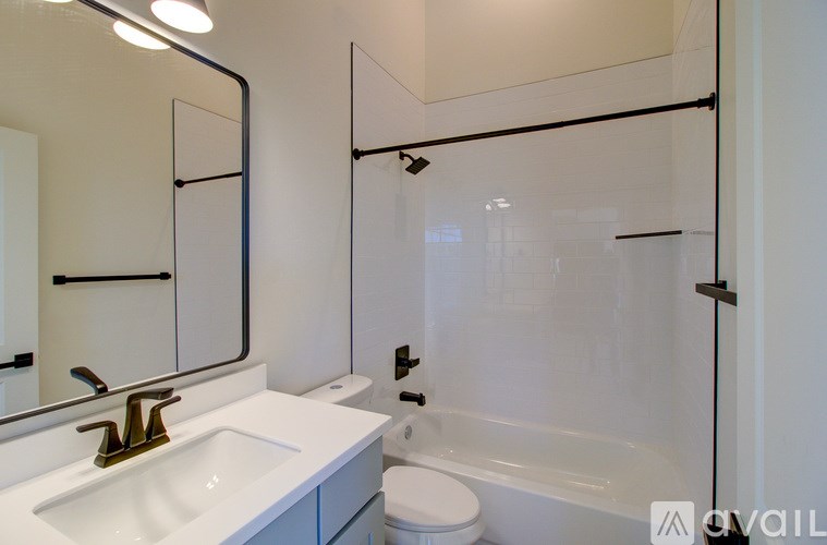 A bathroom with a sink, toilet, and bathtub.