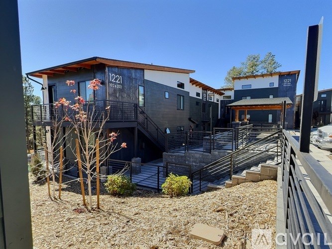 A modern house with the number 1221 on the front.