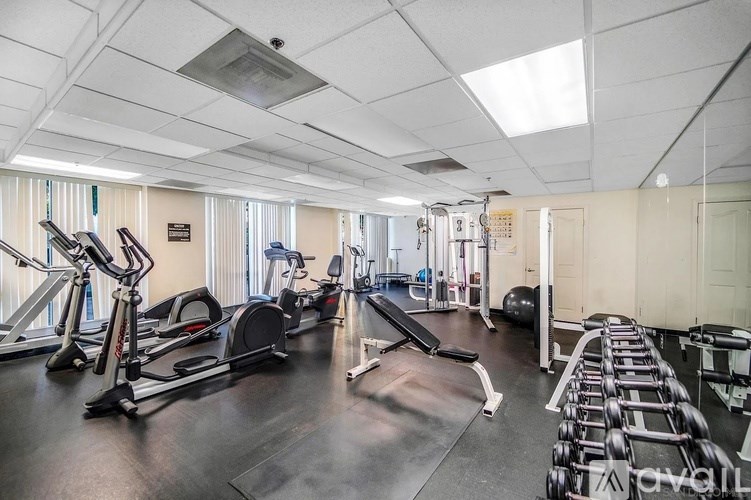 A gym with treadmills, exercise bikes, and weightlifting equipment.