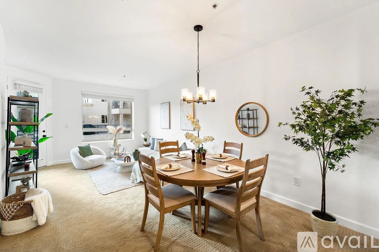 A dining room with a round table and chairs.