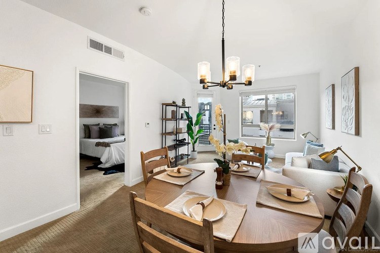 A dining room with a wooden table set for six.