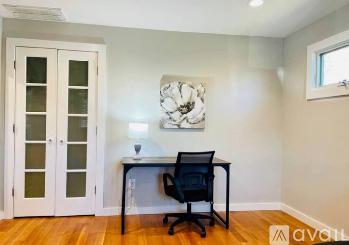 A room with a desk and chair in it.