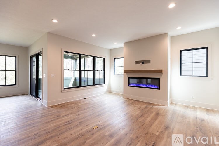 A spacious living room with hardwood floors and a fireplace.