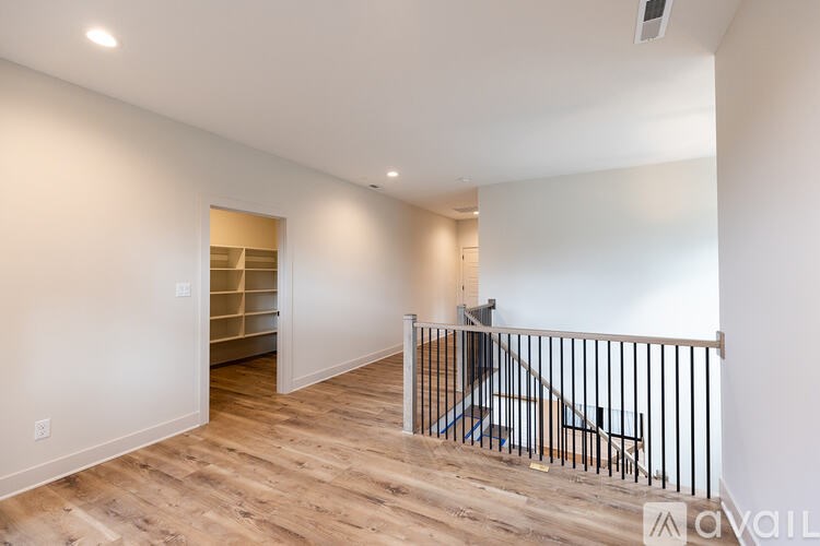 A room with a staircase and a railing.