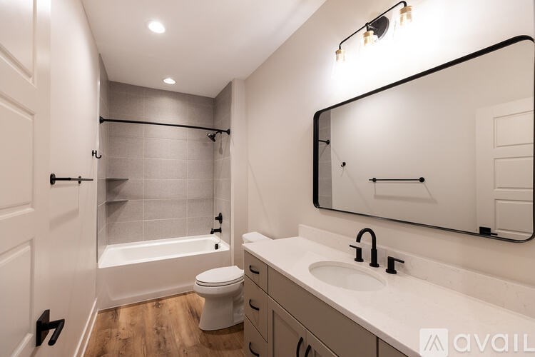 A bathroom with a white toilet, a white sink, and a white bathtub.