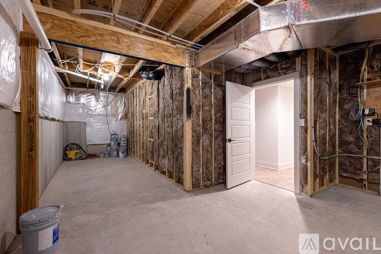 A room under construction with a doorway open to another room.