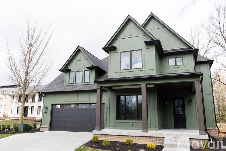 A two-story house with a dark grey garage door.