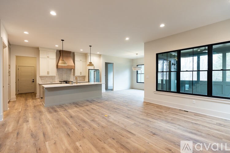 A spacious kitchen with wooden floors and a large island.
