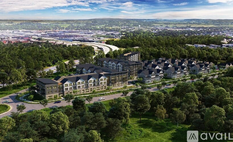 A bird's eye view of a large residential complex surrounded by trees.