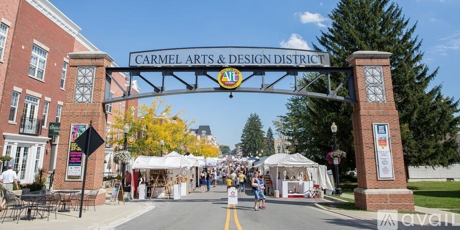A street view of the Carmel Arts & Design District with people walking and stalls set up.