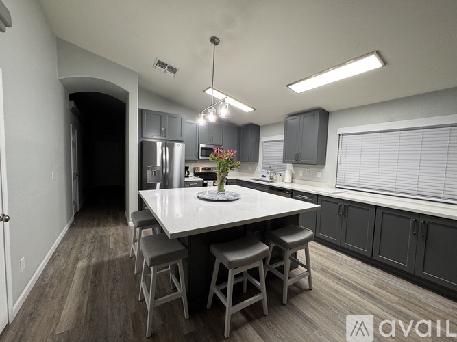 A kitchen with a table and chairs in the middle of the room.