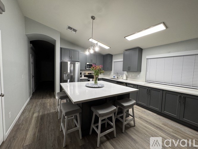 A kitchen with a table and chairs in the middle of the room.