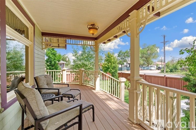 A porch with a table and chairs is shown.