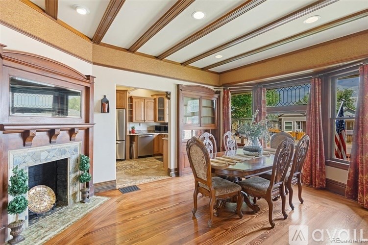 A dining room with a wooden table and chairs.