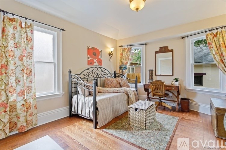 A bedroom with a canopy bed and a desk.