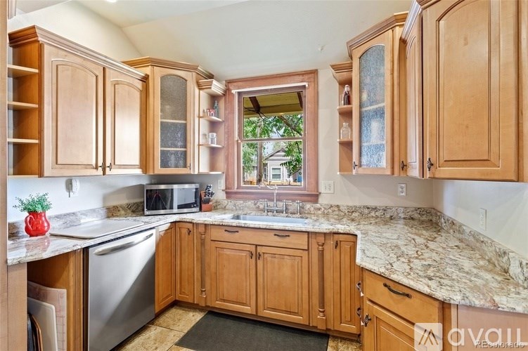 A kitchen with wooden cabinets and granite countertops.
