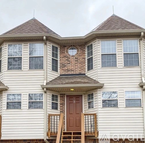 A house with a brown door and windows.
