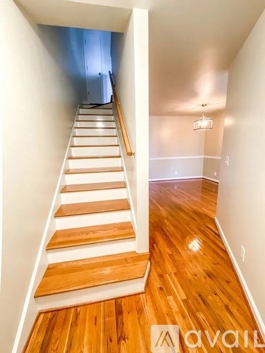 A wooden staircase with a white railing.