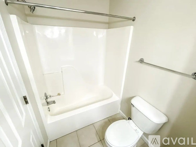 A white bathroom with a toilet and a walk-in shower.