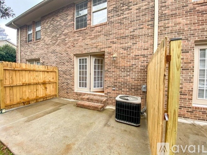 A brick house with a wooden fence and a window.