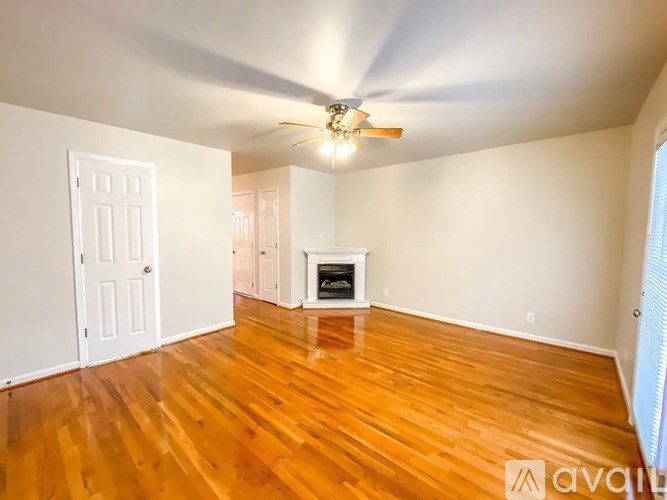 A room with a fireplace and wooden floors.