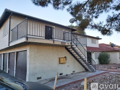 A house with a balcony and stairs leading to the second floor.