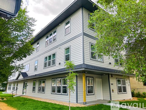 A two-story house with a grey and yellow exterior.