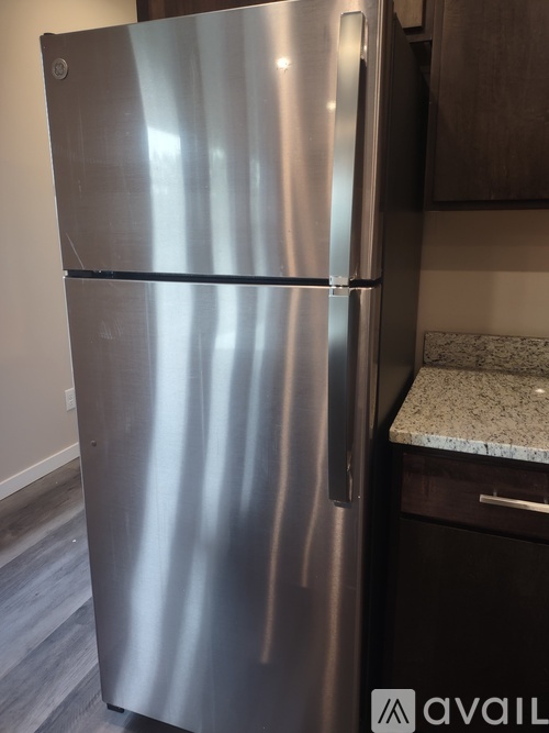 A stainless steel refrigerator in a kitchen.