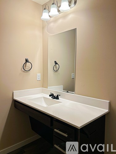 A bathroom with a sink and a mirror.