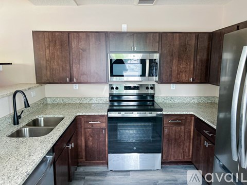 A kitchen with a stove, oven, and refrigerator.