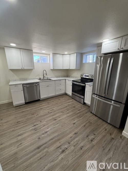 A kitchen with white cabinets and stainless steel appliances.