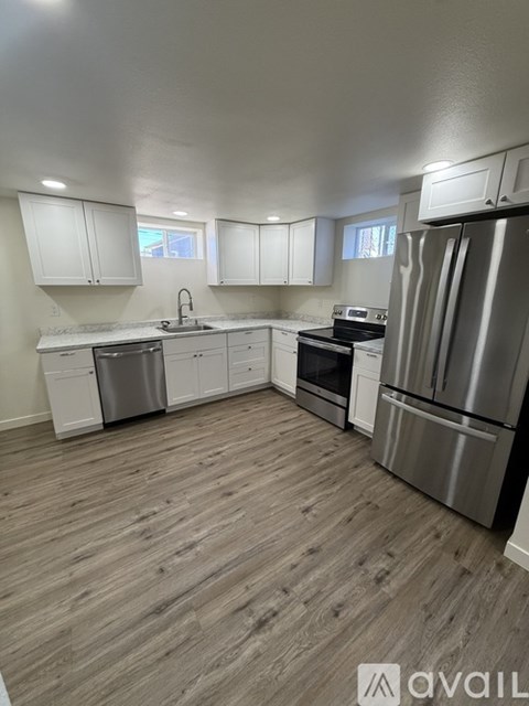 A kitchen with white cabinets and stainless steel appliances.