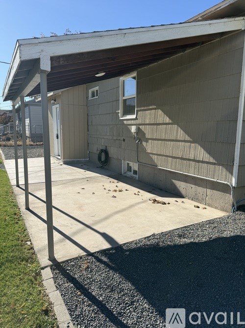 A house with a garage door and a wreath on the door.