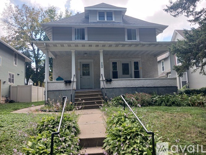 A house with a front porch and a white picket fence.