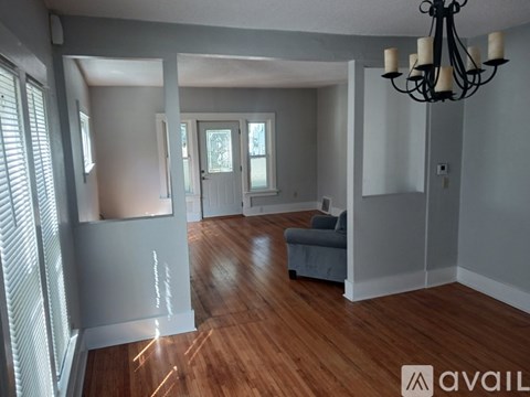A living room with a couch and a chandelier.