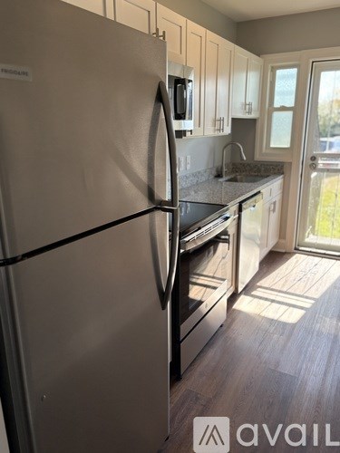 A kitchen with a fridge and a stove.