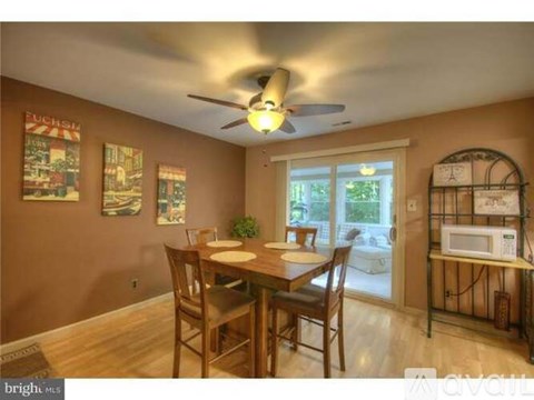 A dining room with a table and chairs.