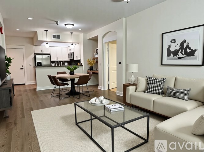 A modern living room with a glass coffee table and a sofa.