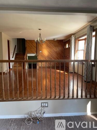 A room with wooden floors and a staircase.