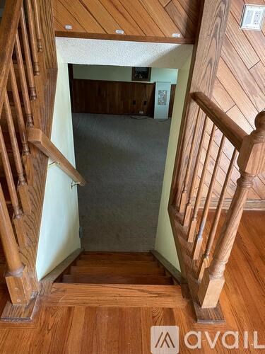 A wooden staircase with a landing visible in the distance.