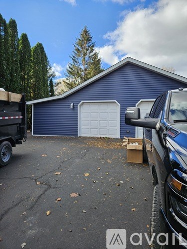 A wooden staircase with a metal railing.