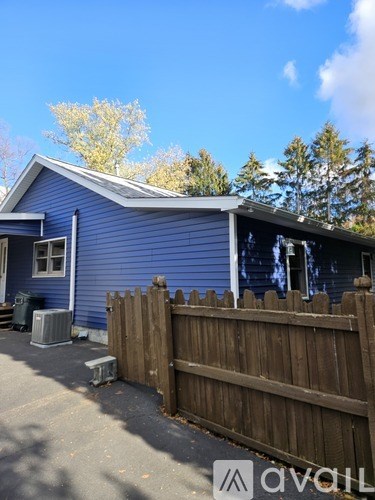 A white pantry with shelves and a door.
