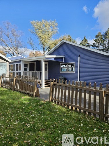 A bathroom with a toilet, sink, and bathtub.