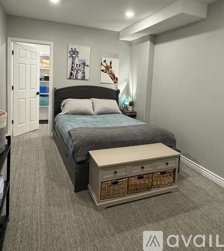 A bedroom with a bed, nightstand, and a wall art.