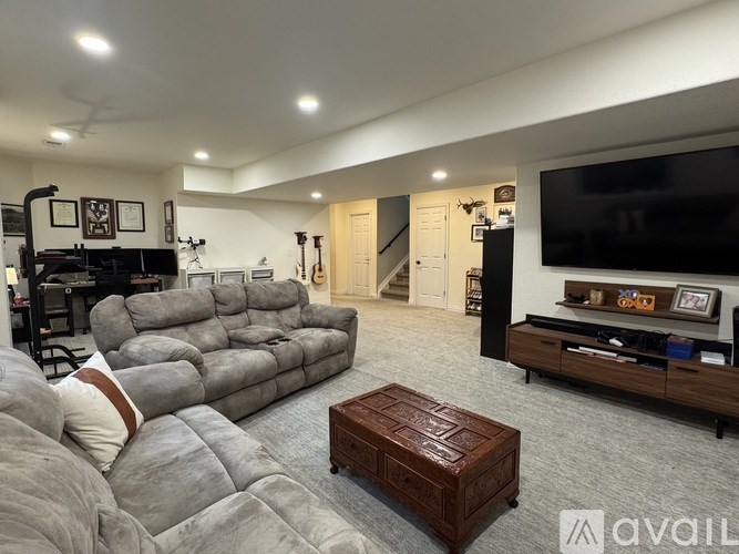 A living room with a grey sofa and a wooden coffee table.