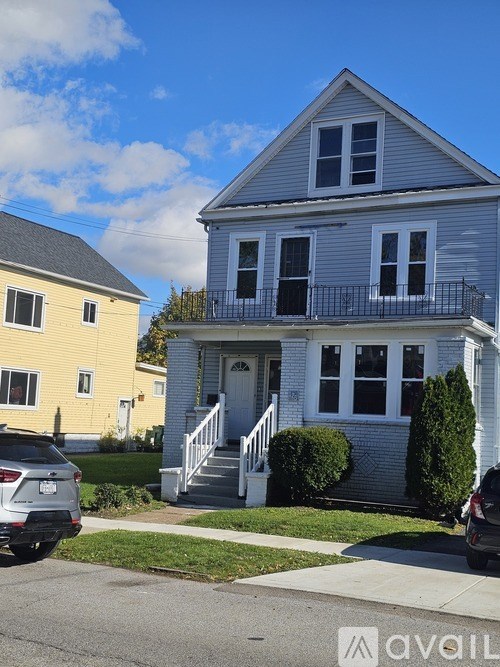A two-story house with a balcony on the second floor.