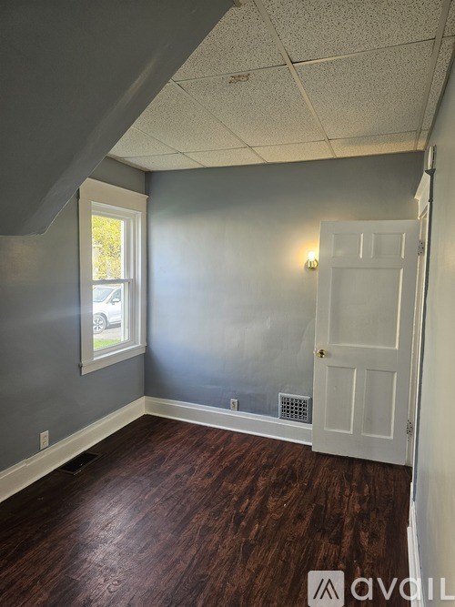 A room with a white door and a window.
