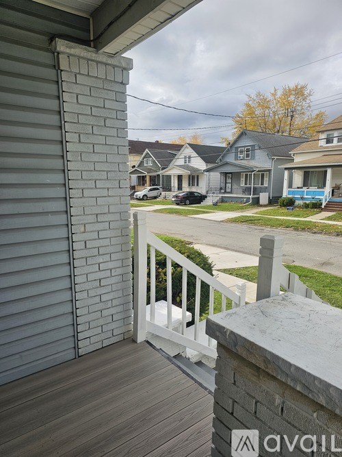 A view from a deck looking out at a residential street.