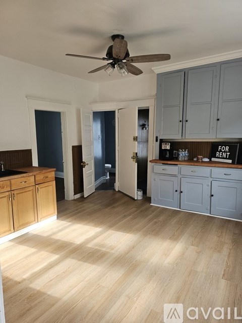 A kitchen with a sign that says "For Rent" on the counter.